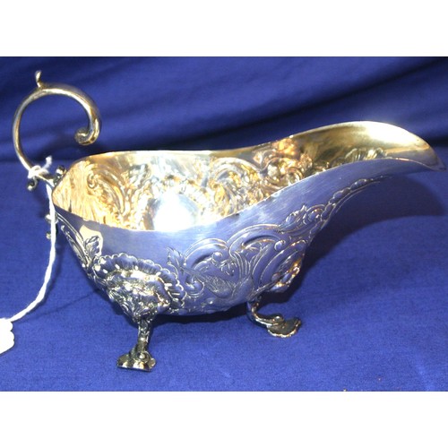 281 - Irish silver boat shaped sauceboat decorated with birds, scrolls, swags and cartouche, S-scroll hand... 