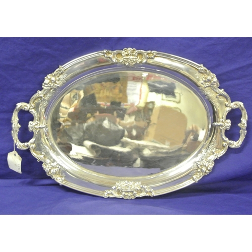 299 - Royal Irish silver oval serving tray with foliate and scroll borders, shaped handles, Dublin 1971. 1... 