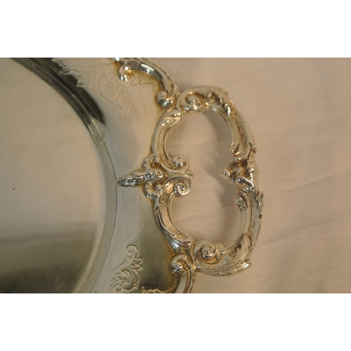 299 - Royal Irish silver oval serving tray with foliate and scroll borders, shaped handles, Dublin 1971. 1... 