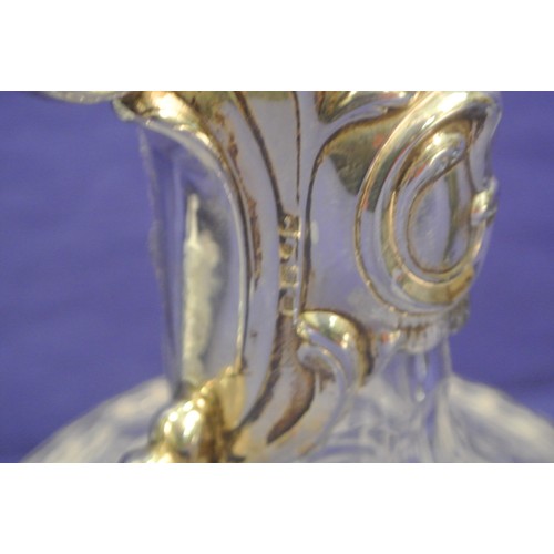 94 - Victorian style glass claret jug with silverplated handle and top. H 25cm