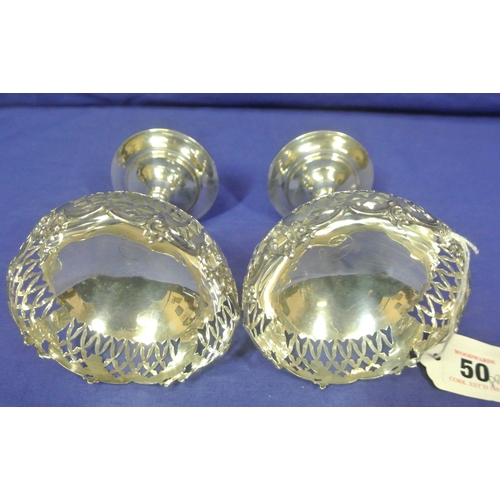 50 - Pair of Birmingham silver stemmed vases with pierced and foliate decoration, on round bases 163g, 11... 