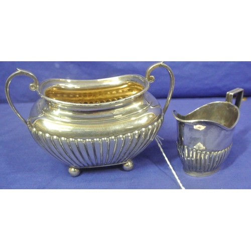 66 - Sheffield silver sugar bowl and creamer with reeded decoration and shaped handles. 310g