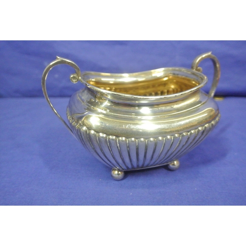 66 - Sheffield silver sugar bowl and creamer with reeded decoration and shaped handles. 310g