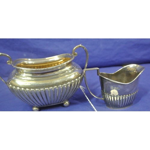 66 - Sheffield silver sugar bowl and creamer with reeded decoration and shaped handles. 310g