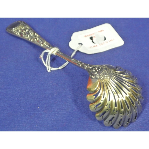 86 - Sheffield silver sugar sifter with pierced shell bowl, ornately decorated handle