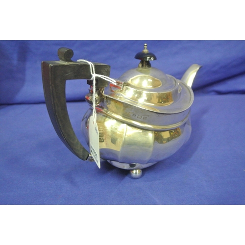 99 - Birmingham silver teapot of oval panelled form with shaped handle and spout, on 4 ball feet