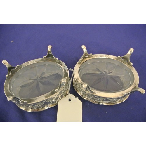 113 - Pair of Victorian London silver oval salts with ornate piercing shaped rims, hand cut glass liners, ... 