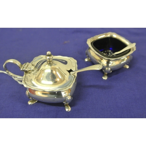 115 - George V Birmingham silver mustard pot and salt with wavy rims, cast feet and blue glass liners, 193... 