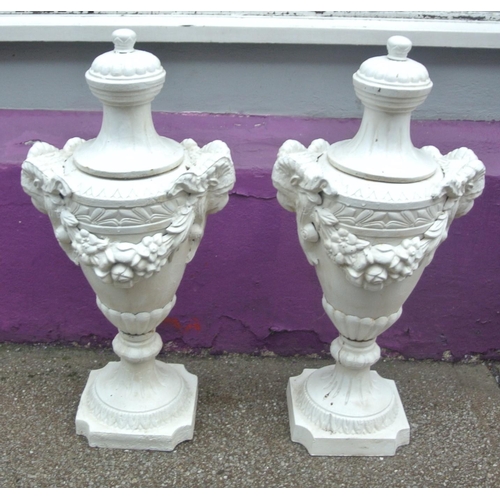 138 - Pair of Georgian style cast iron garden vases with shaped tops, ram head handles, grapevine decorate... 