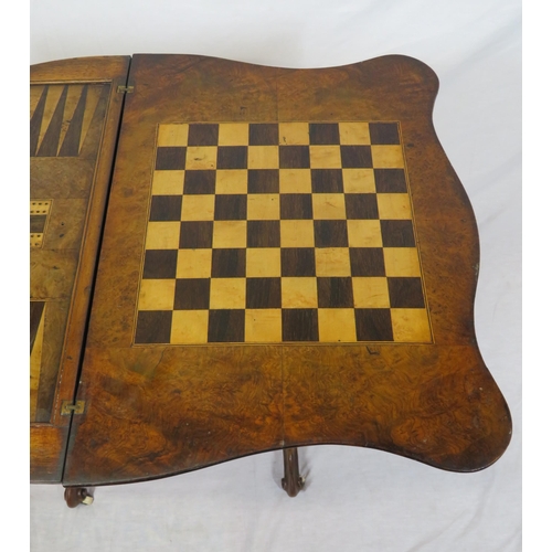 136 - Victorian walnut games table with fold-over top, serpentine borders, chess & backgammon inlaid top, ... 