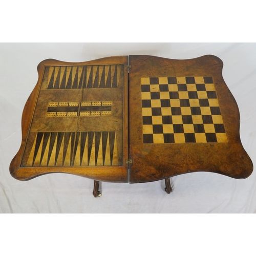 136 - Victorian walnut games table with fold-over top, serpentine borders, chess & backgammon inlaid top, ... 