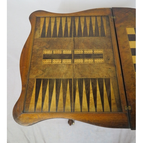 136 - Victorian walnut games table with fold-over top, serpentine borders, chess & backgammon inlaid top, ... 