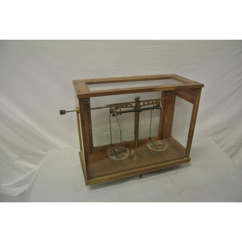 142 - Gallenkamp brass & metal weighing scales, glazed case, with adjustable legs