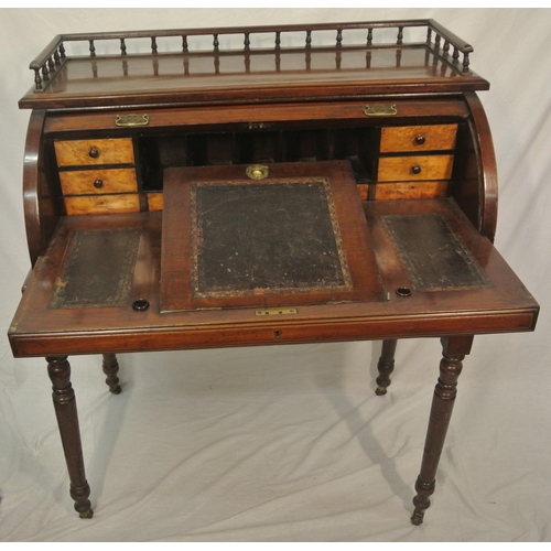 145 - Victorian mahogany desk with railed top, tambour pull-down front, fitted interior, pull-out writing ... 