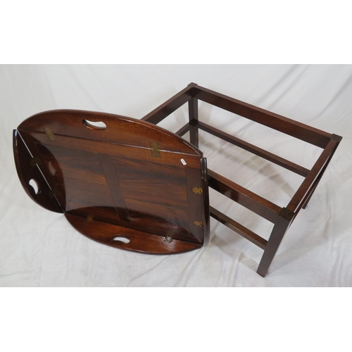 146 - Edwardian mahogany butlers tray with folding demi-lune pierced handles on stand with stretchers