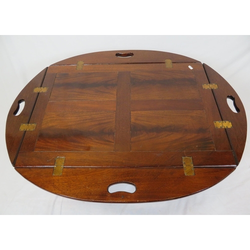 146 - Edwardian mahogany butlers tray with folding demi-lune pierced handles on stand with stretchers