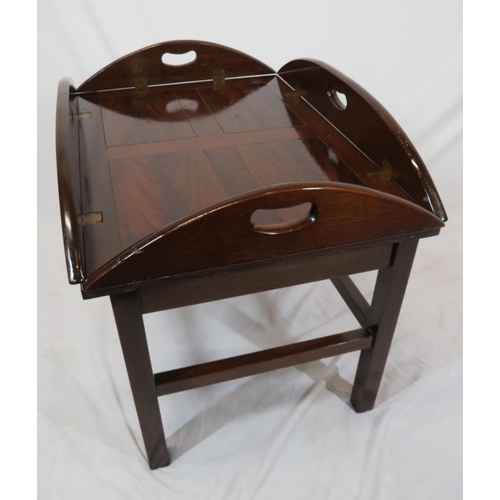 146 - Edwardian mahogany butlers tray with folding demi-lune pierced handles on stand with stretchers