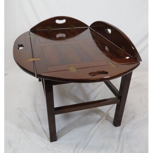 146 - Edwardian mahogany butlers tray with folding demi-lune pierced handles on stand with stretchers