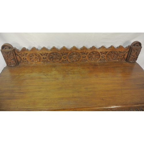 39 - Victorian oak side table with ornate foliate carving, on ball turned legs with stretchers