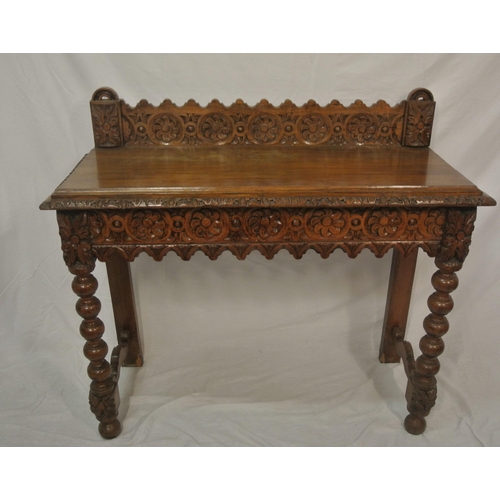 39 - Victorian oak side table with ornate foliate carving, on ball turned legs with stretchers