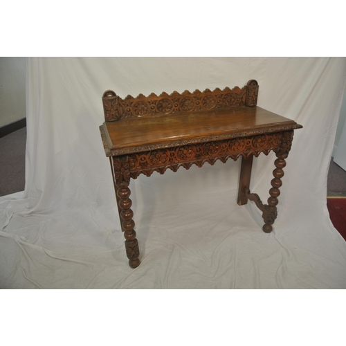 39 - Victorian oak side table with ornate foliate carving, on ball turned legs with stretchers