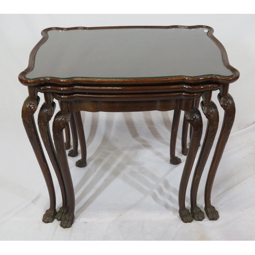 46 - Victorian nest of three mahogany glass topped tables with serpentine borders, on carved cabriole leg... 