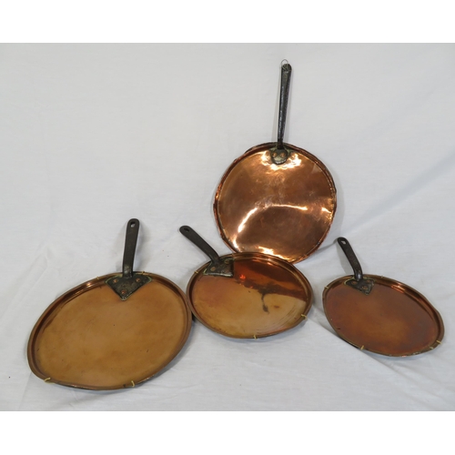 47 - Four Georgian style copper pans with metal handles