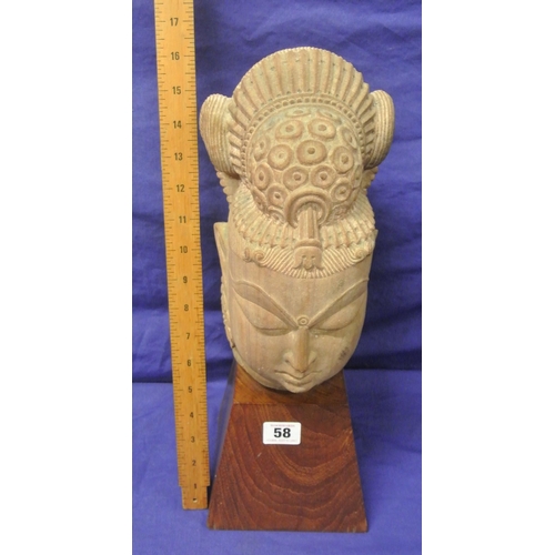 58 - Oriental carved sandstone bust on tapering timber base