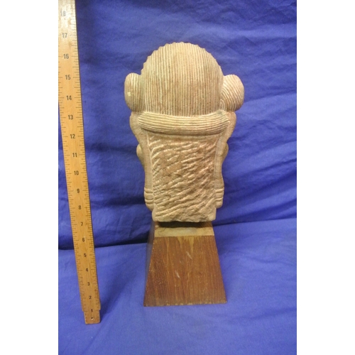 58 - Oriental carved sandstone bust on tapering timber base