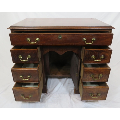 65 - Edwardian mahogany kneehole desk with seven drawers, shaped brass drop handles, on bracket feet