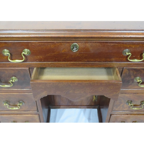 65 - Edwardian mahogany kneehole desk with seven drawers, shaped brass drop handles, on bracket feet