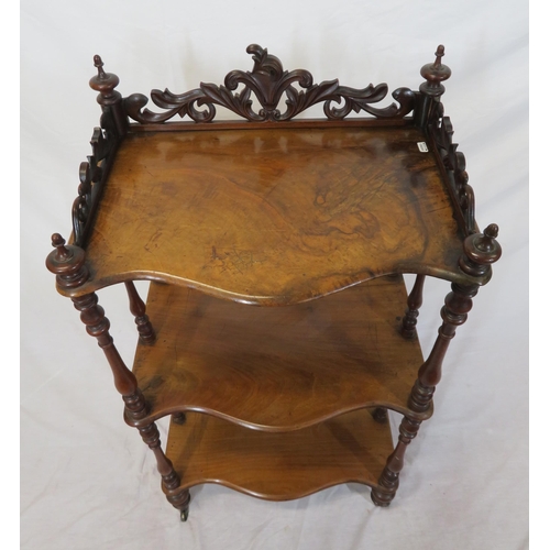 71 - Victorian walnut three tier whatnot with serpentine shaped fronts, pierced gallery, shaped finials, ... 