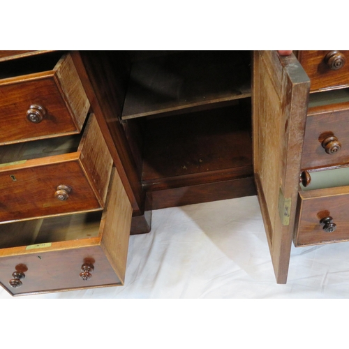 95 - Edwardian mahogany desk with two frieze drawers, three side drawers, central press, on shaped plinth