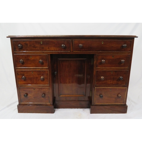 95 - Edwardian mahogany desk with two frieze drawers, three side drawers, central press, on shaped plinth