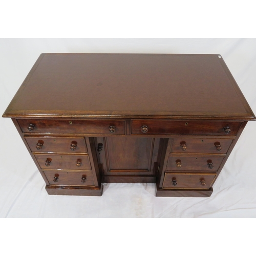 95 - Edwardian mahogany desk with two frieze drawers, three side drawers, central press, on shaped plinth