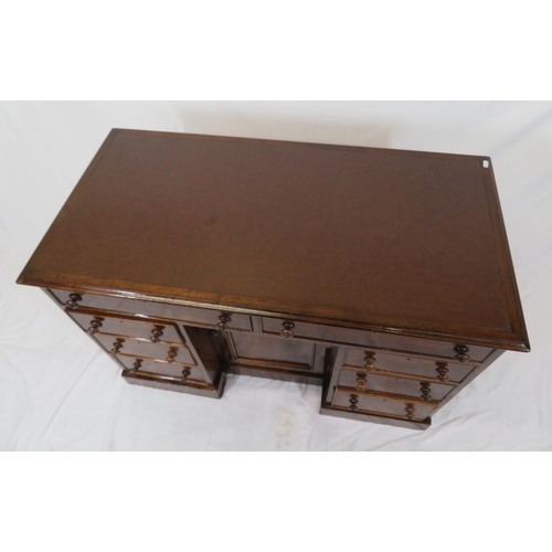 95 - Edwardian mahogany desk with two frieze drawers, three side drawers, central press, on shaped plinth