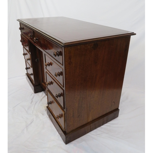 95 - Edwardian mahogany desk with two frieze drawers, three side drawers, central press, on shaped plinth