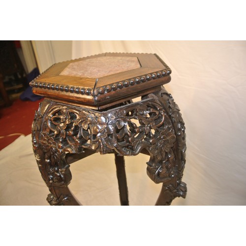 217 - Oriental hexagonal carved teak jardiniere or bust stand with marble inset, ornate foliate & scroll c... 