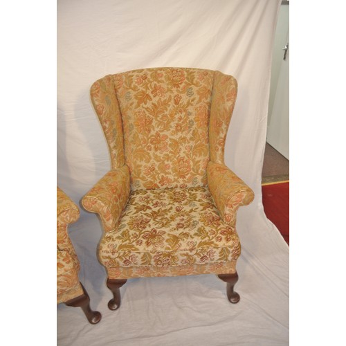 320 - Pair of Victorian style wingback armchairs with foliate upholstery, on cabriole legs with pad feet