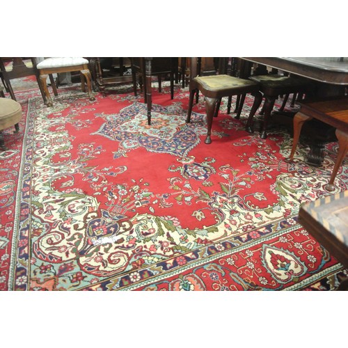 72 - Large multi coloured field Persian Tabriz carpet with rich colours on a floral field 380x290cm