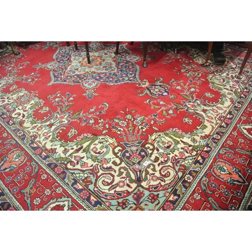 72 - Large multi coloured field Persian Tabriz carpet with rich colours on a floral field 380x290cm