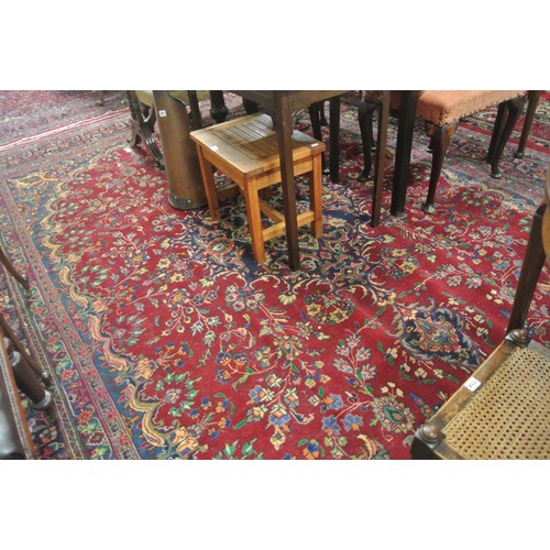 194 - Fine hand woven rich red ground Persian Mashad carpet of traditional floral design 390 x280 cm