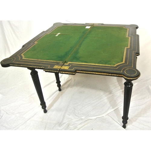 125 - French Empire style ebonised card table with fold-over top, brass inlay, 'dog-ear' candle corners, r... 