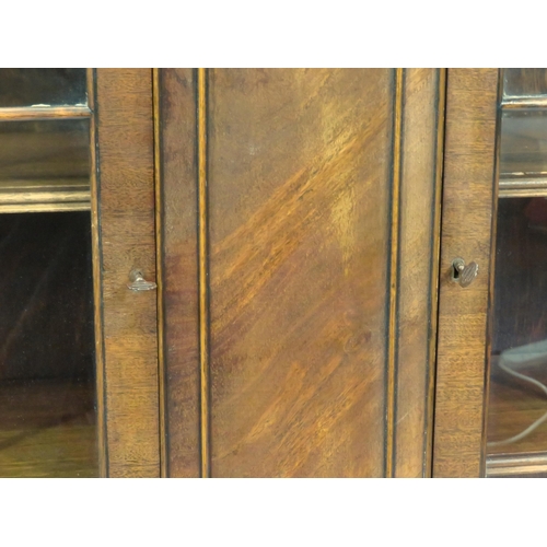 15 - Edwardian style mahogany bookcase with glazed doors, adjustable shelving, on bracket feet