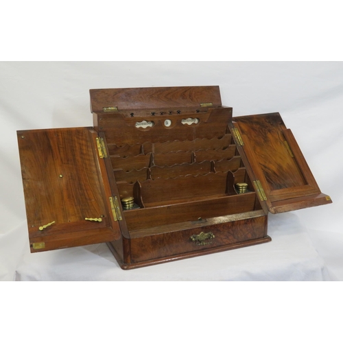 47 - Edwardian walnut stationery box with fold-out front & lid, lined interior, inkwells, drawer under wi... 