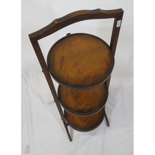 9 - Three tier mahogany adjustable plate stand with shaped handle