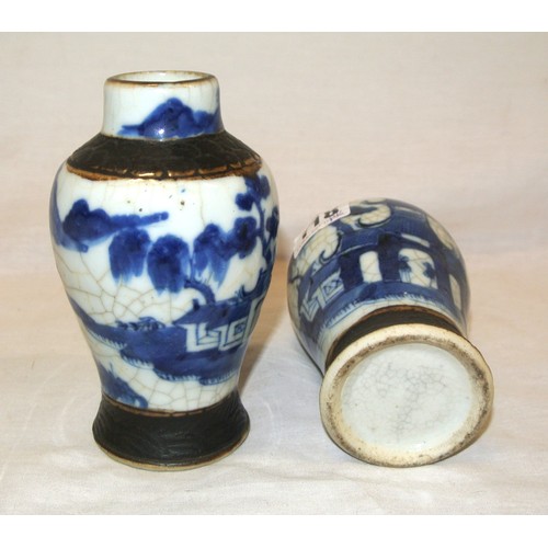 167 - Pair of Oriental baluster shaped blue & white scenic decorated bud vases