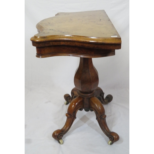 220 - Victorian walnut card table with serpentine shaped sides, swivel fold-over top, hexagonal baluster c... 