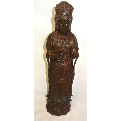 293 - Oriental metal figure of a man holding a vase, on shaped base