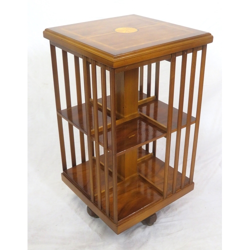 104 - Edwardian style inlaid & crossbanded mahogany revolving bookcase with railed sides, shell inlay, on ... 